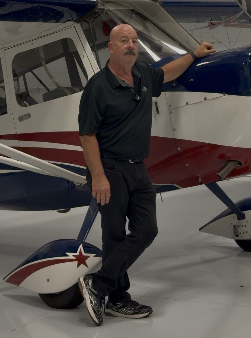 Chip Bornstein standing beside the Super Decathlon